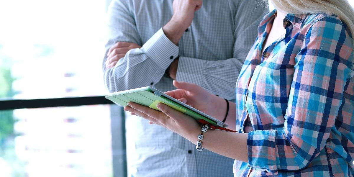 Two Business People Working With Tablet in startup office