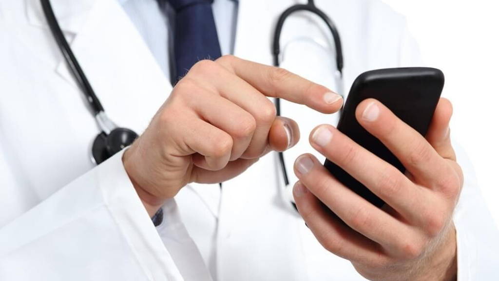 Doctor hands texting on a smart phone