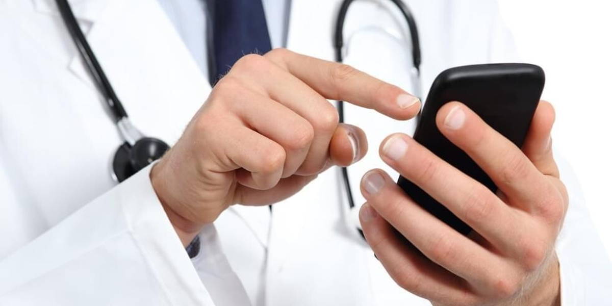 Doctor hands texting on a smart phone