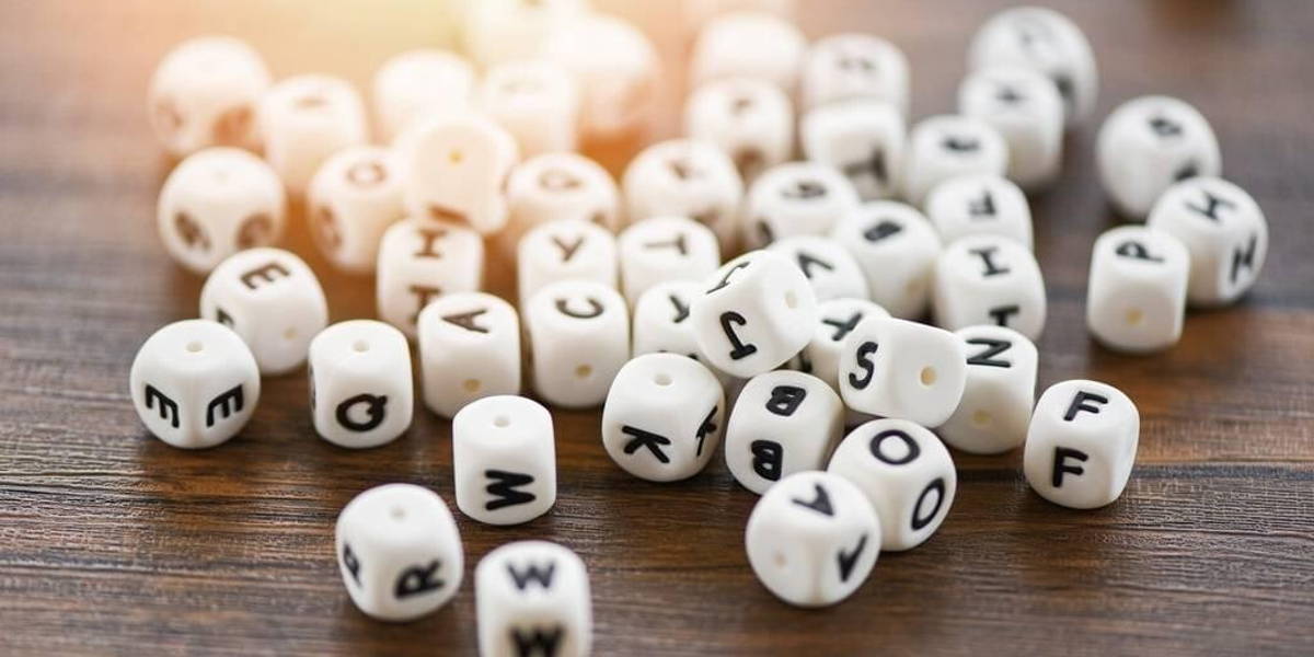 Text dice cube concept Letter dices alphabet on wooden backgroun