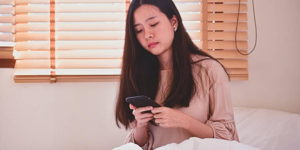 Women hording mobile smartphone  on bedroom