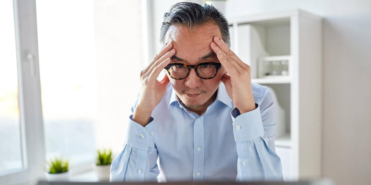 businessman in eyeglasses with laptop at office