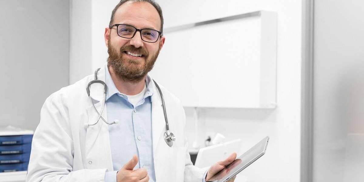 Friendly male doctor smiling and giving thumb up sign