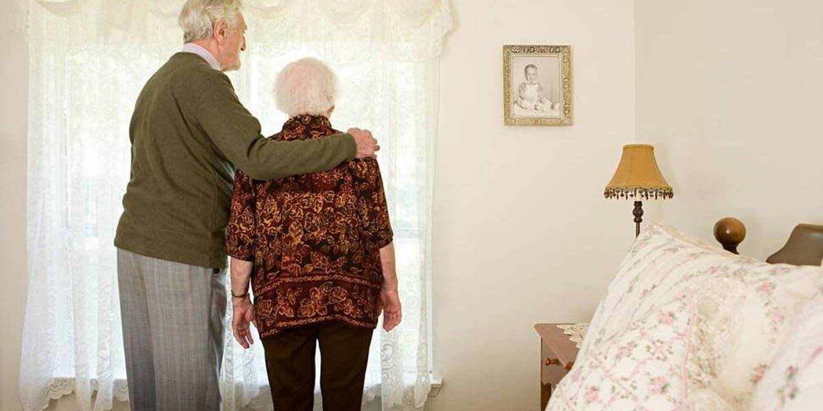 Elderly couple in their bedroom