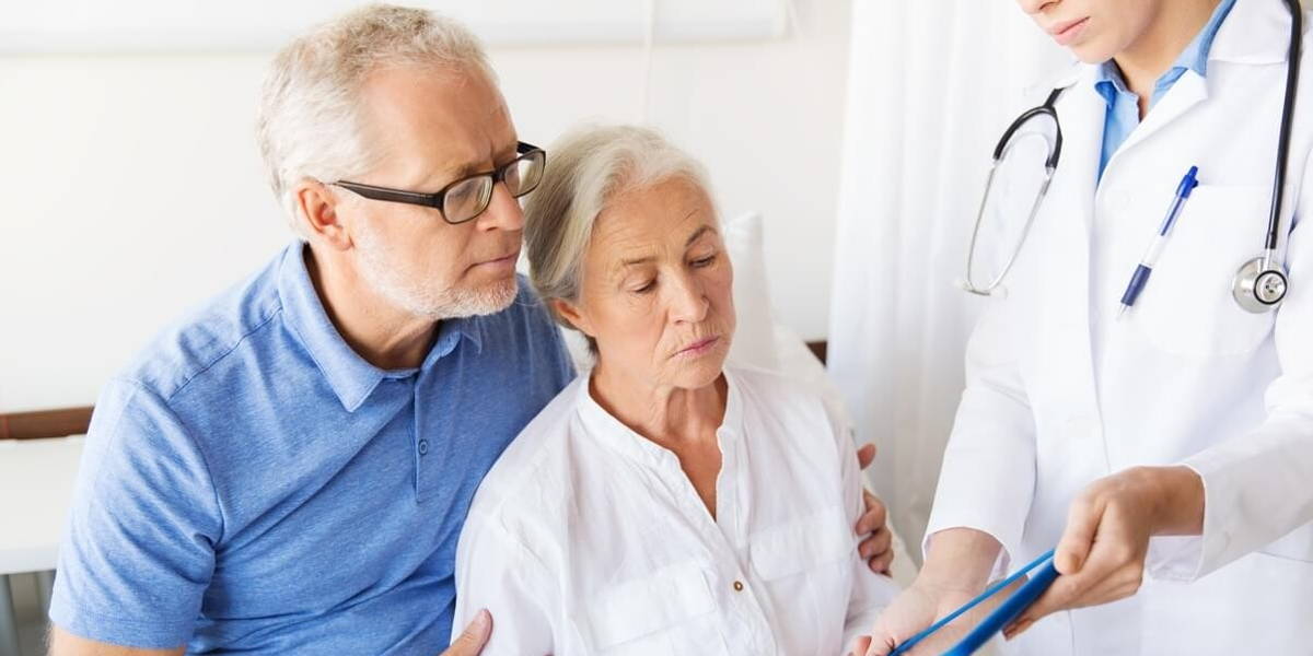 senior woman and doctor with tablet pc at hospital