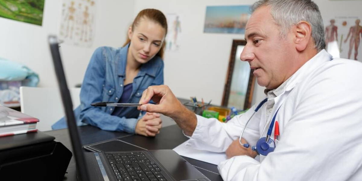 doctor checking blood test results in hospitals computer system