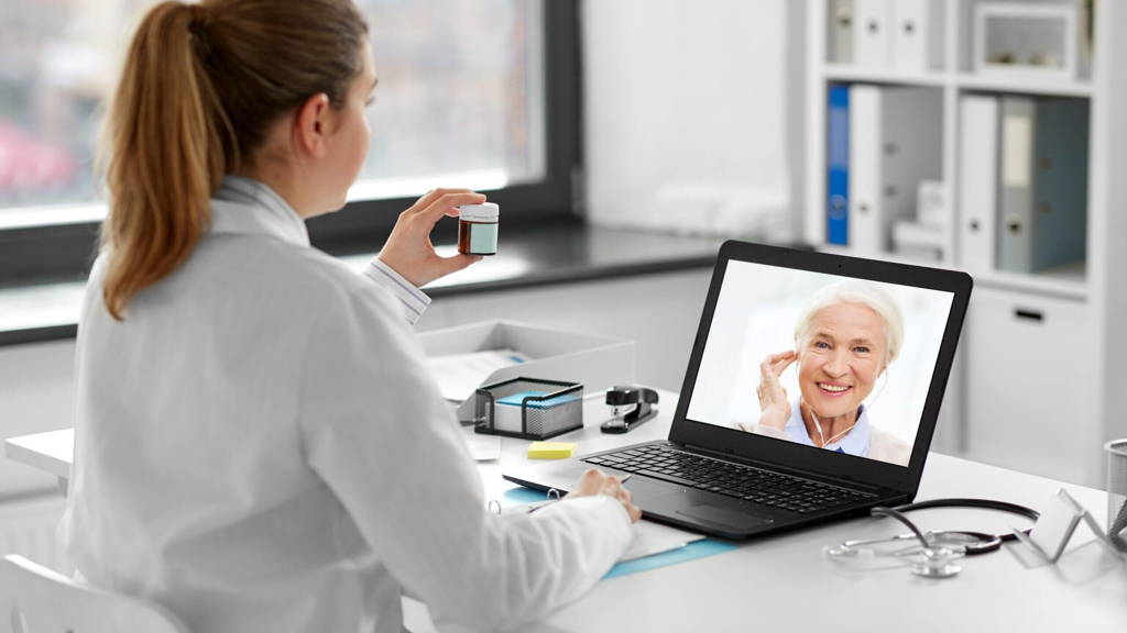 doctor with laptop having video call with patient