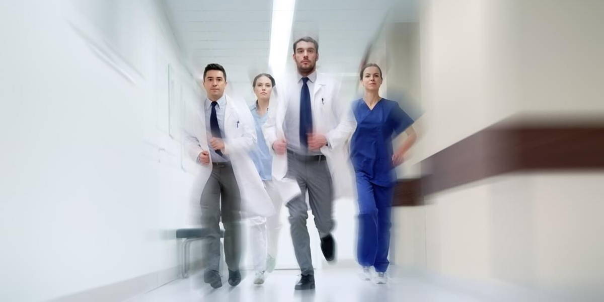 group of medics walking along hospital