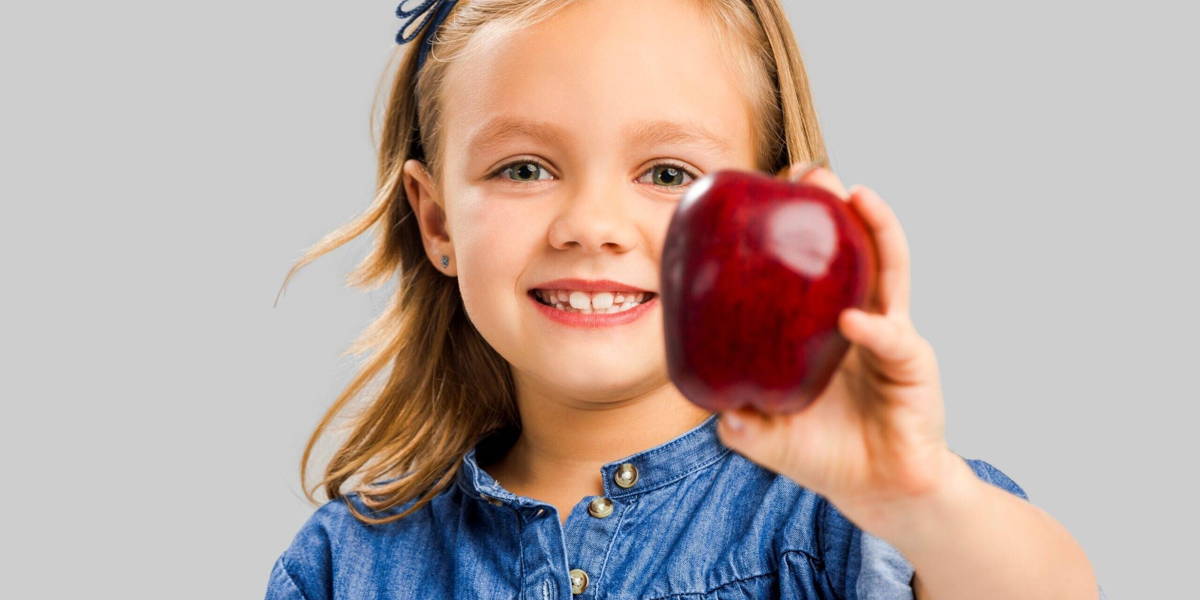 Cute girl holding an apple