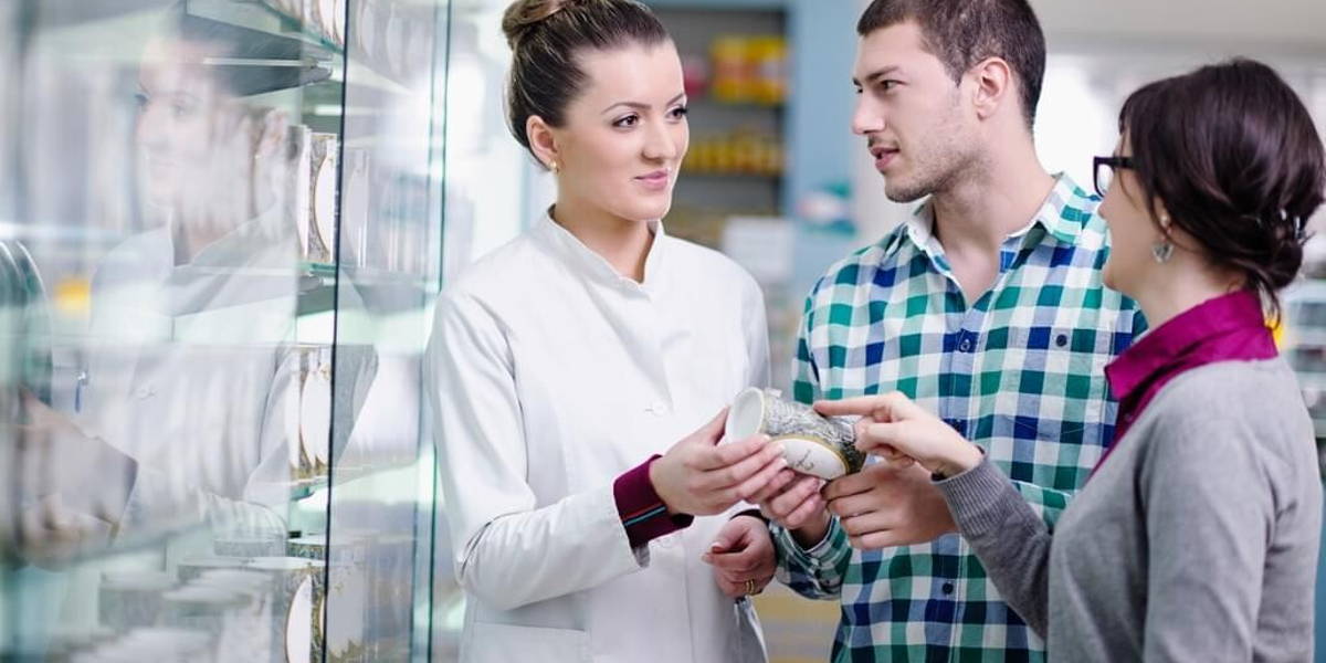 pharmacist suggesting medical drug to buyer in pharmacy drugstor