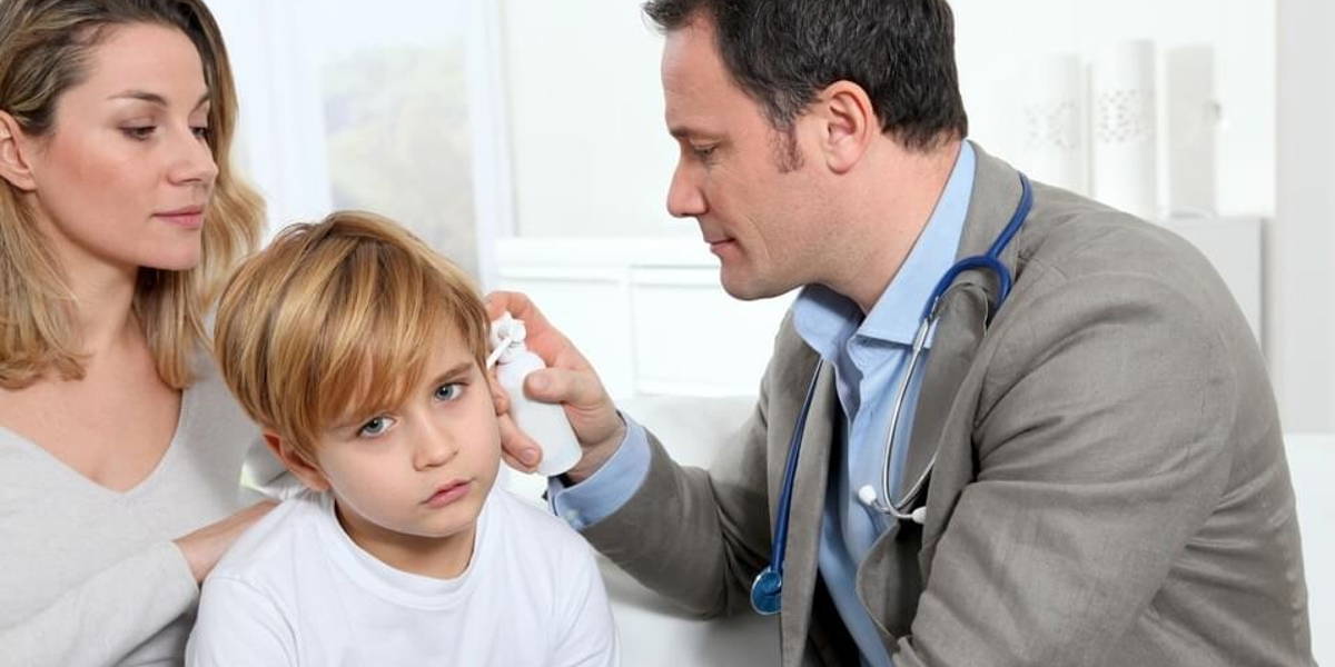 Doctor cheking little boy's ear infection