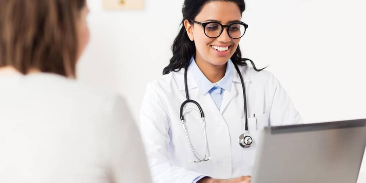 doctor with laptop and woman patient at hospital