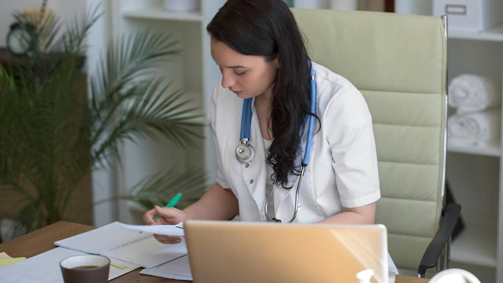 Doctor working with test results and computer