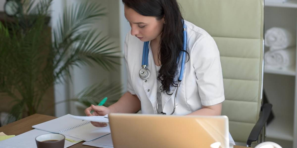 Doctor working with test results and computer