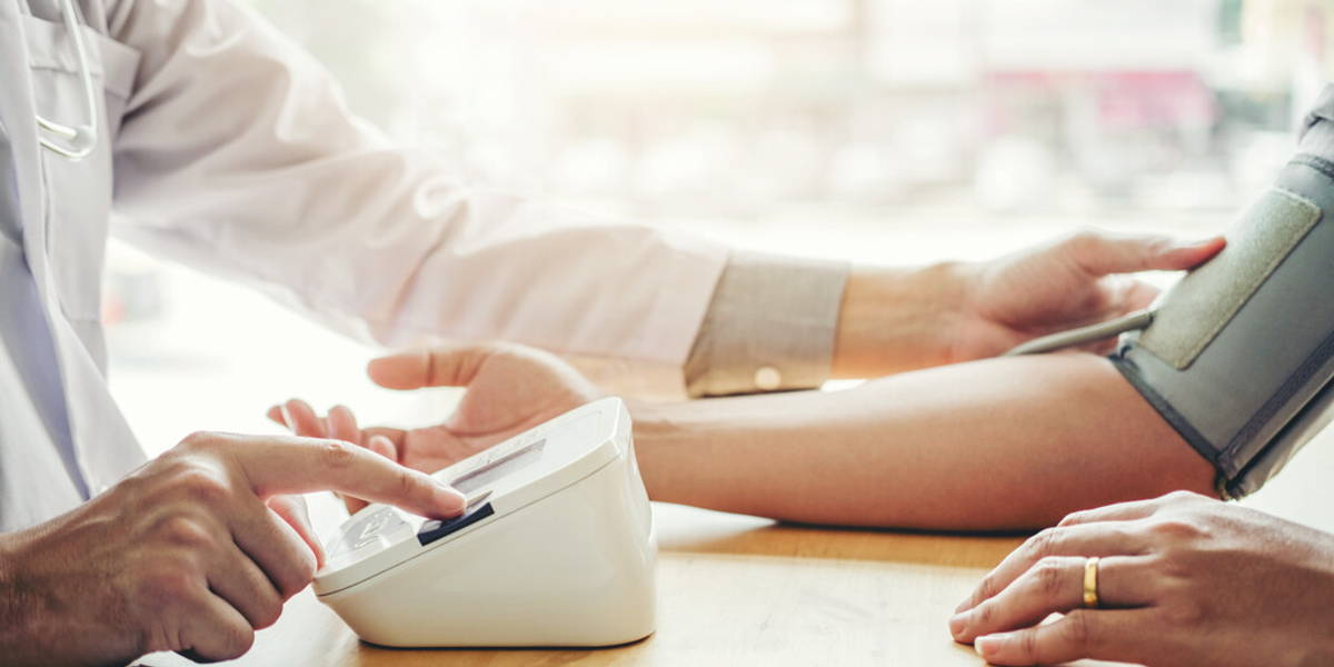 Doctor Measuring arterial blood pressure man patient on arm Heal