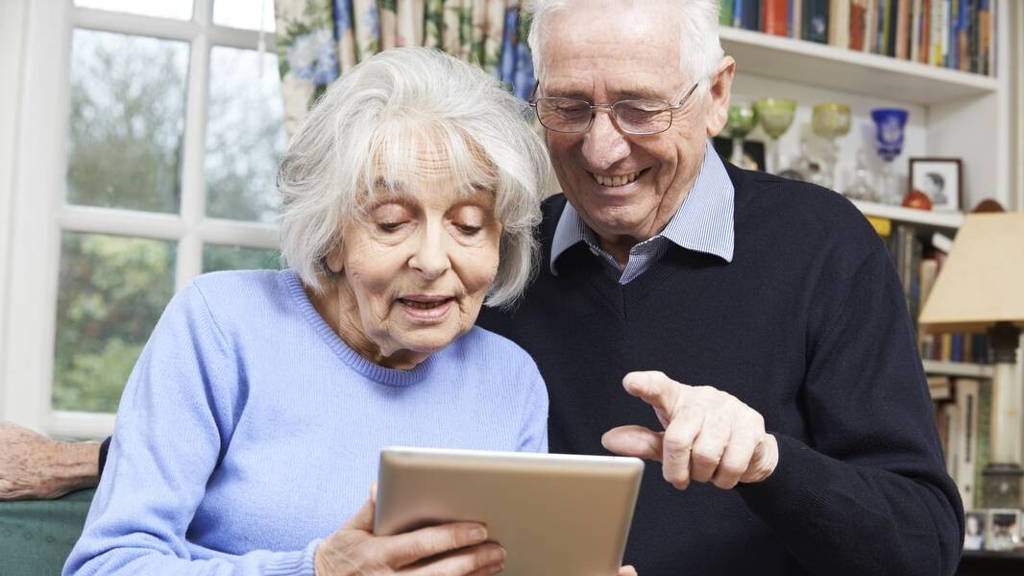 Senior Couple Using Digital Tablet At Home