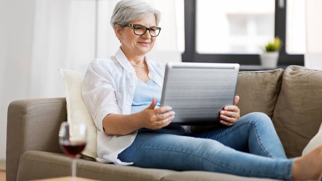 senior woman with on laptop resting at home