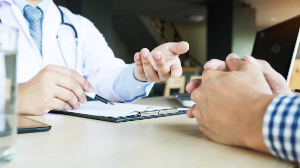 patient listening intently to a male doctor explaining patient s