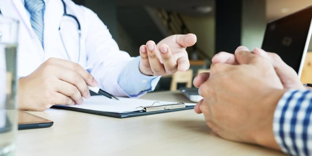 patient listening intently to a male doctor explaining patient s