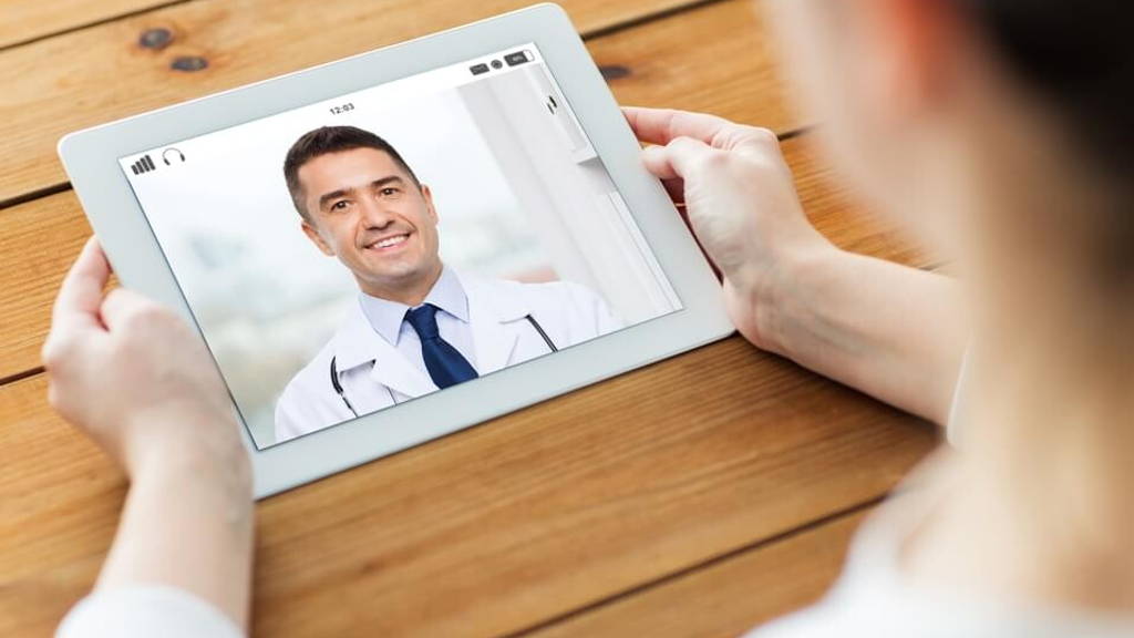patient having video chat with doctor on tablet pc