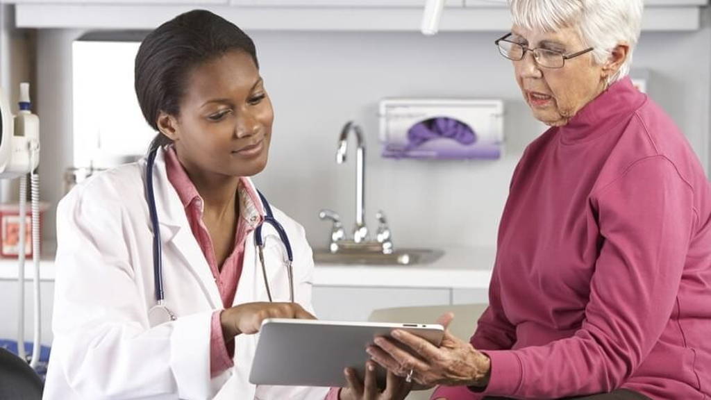 Doctor Discussing Records With Senior Female Patient