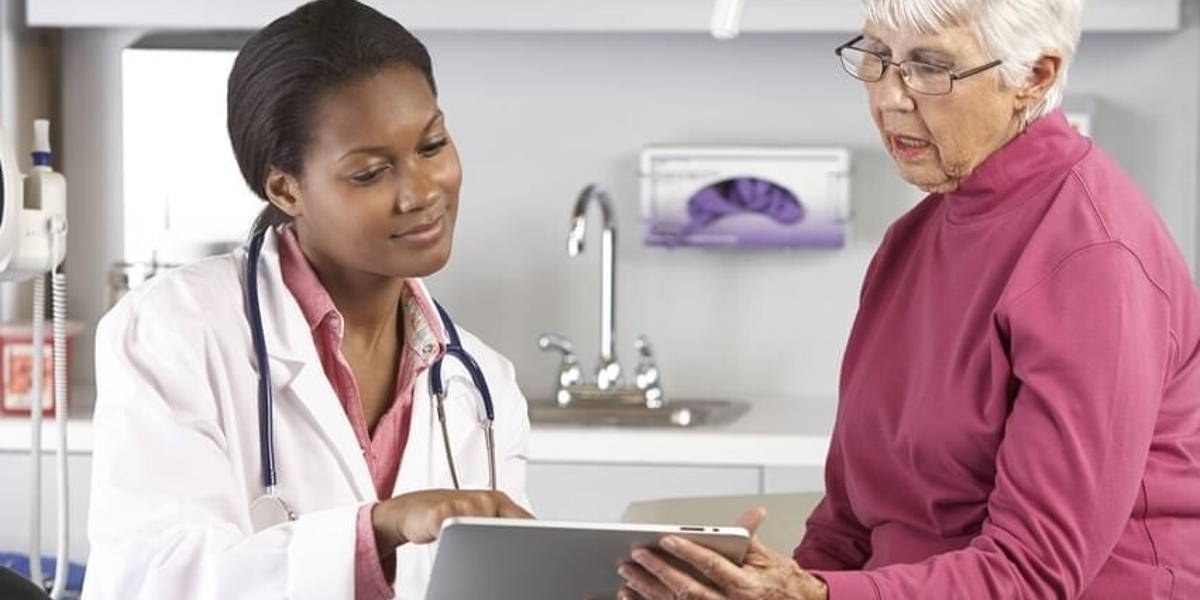 Doctor Discussing Records With Senior Female Patient