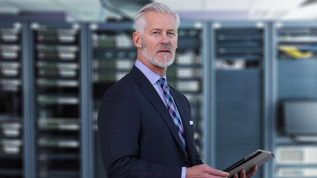 Senior businessman in network server room