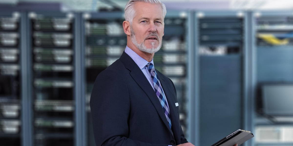 Senior businessman in network server room