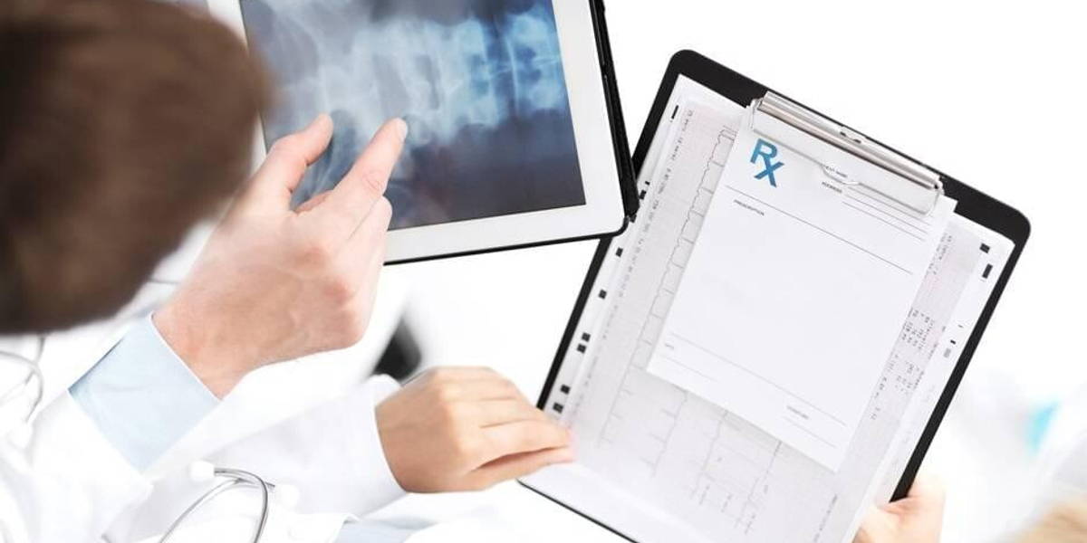 group of doctors looking at x-ray on tablet pc