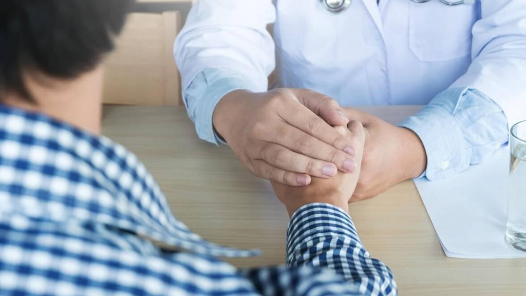Hand of doctor reassuring his patient