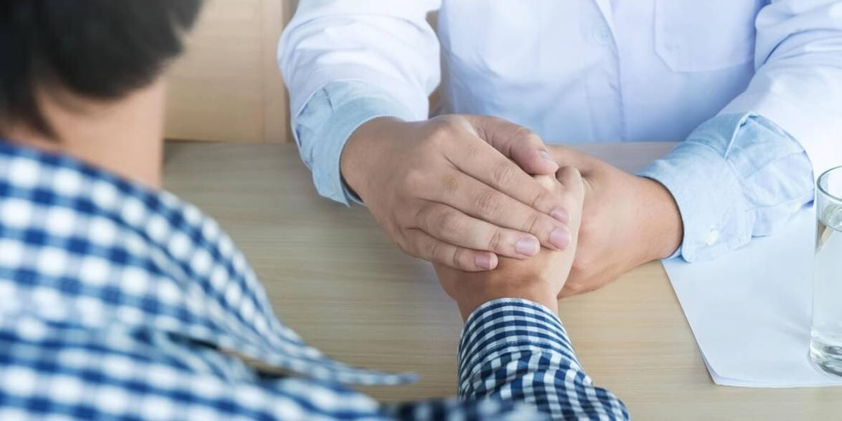 Hand of doctor reassuring his patient