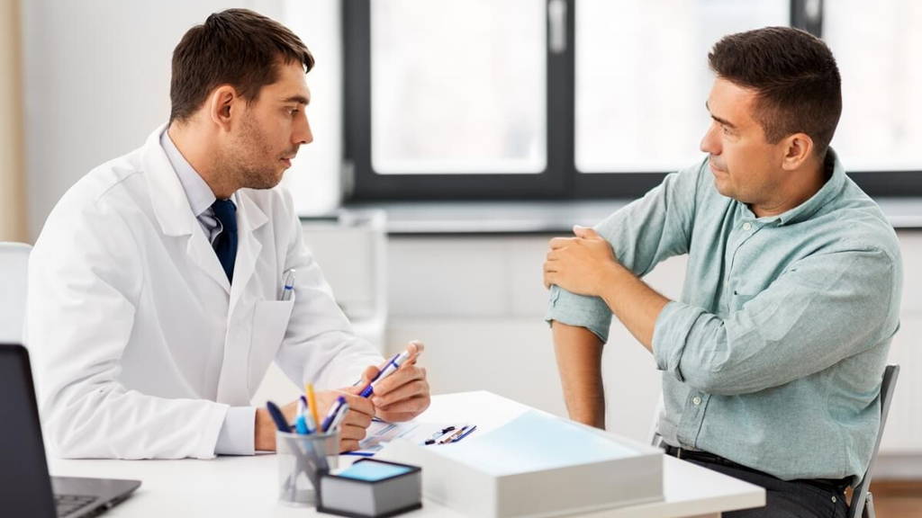 patient showing sore arm to doctor at hospital