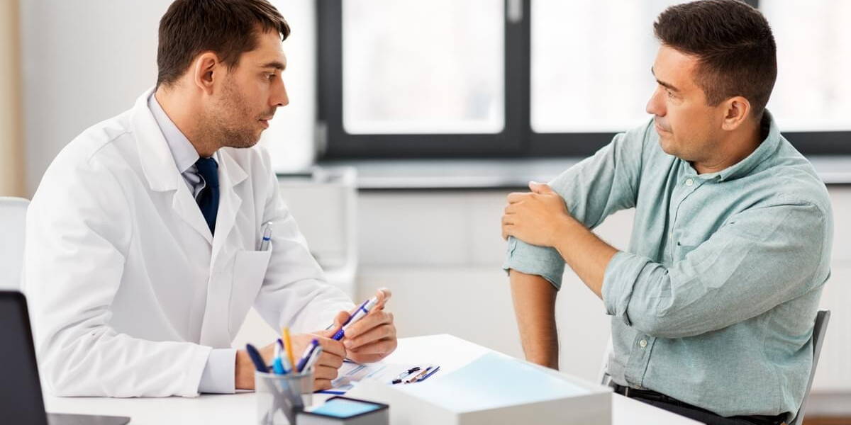 patient showing sore arm to doctor at hospital