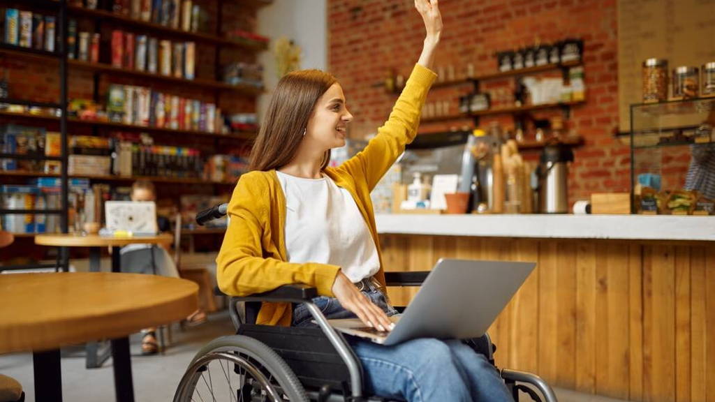 Disabled student in wheelchair with raised hand
