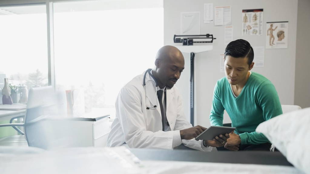 Doctor and patient looking at digital tablet