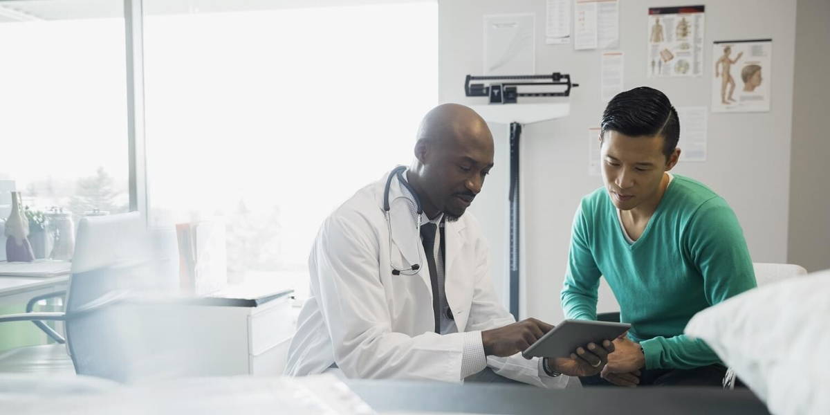 Doctor and patient looking at digital tablet