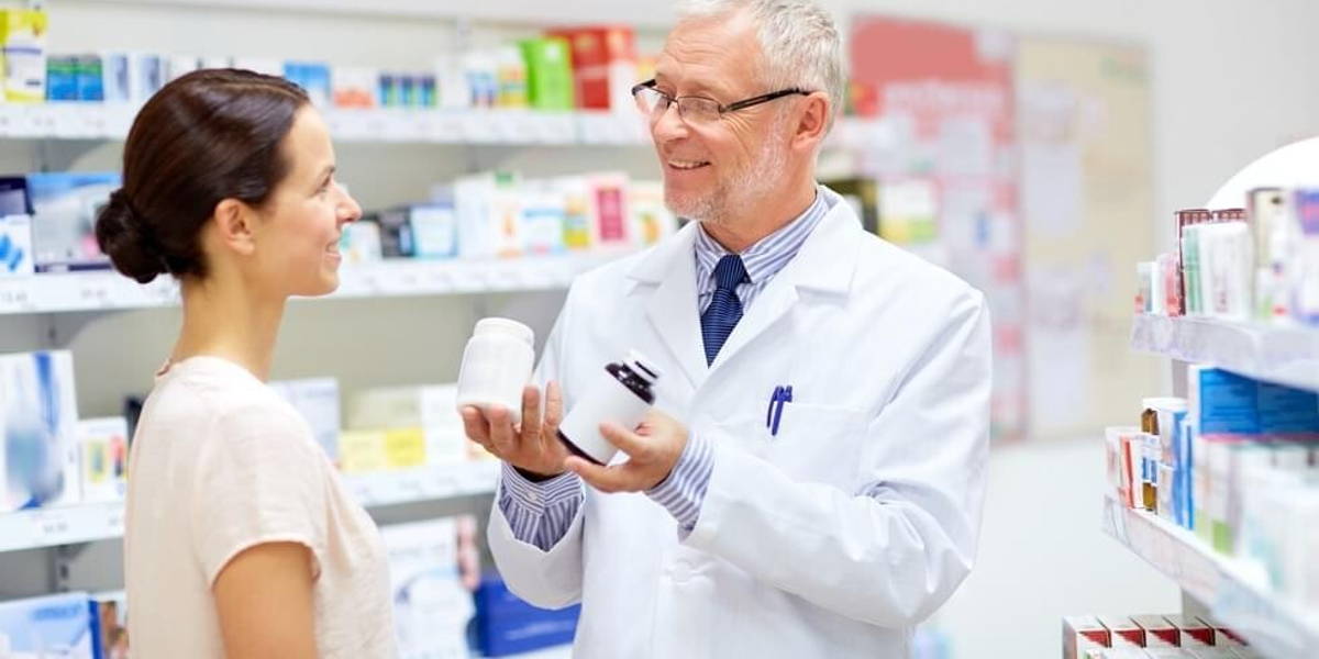 apothecary and woman with drug at pharmacy