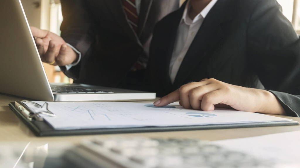 Business executives analysis data document with accountant at wo