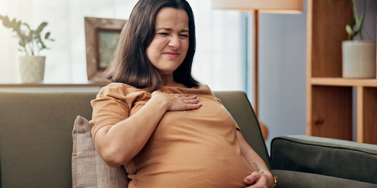 Zwangere, pijnlijk kijkende vrouw