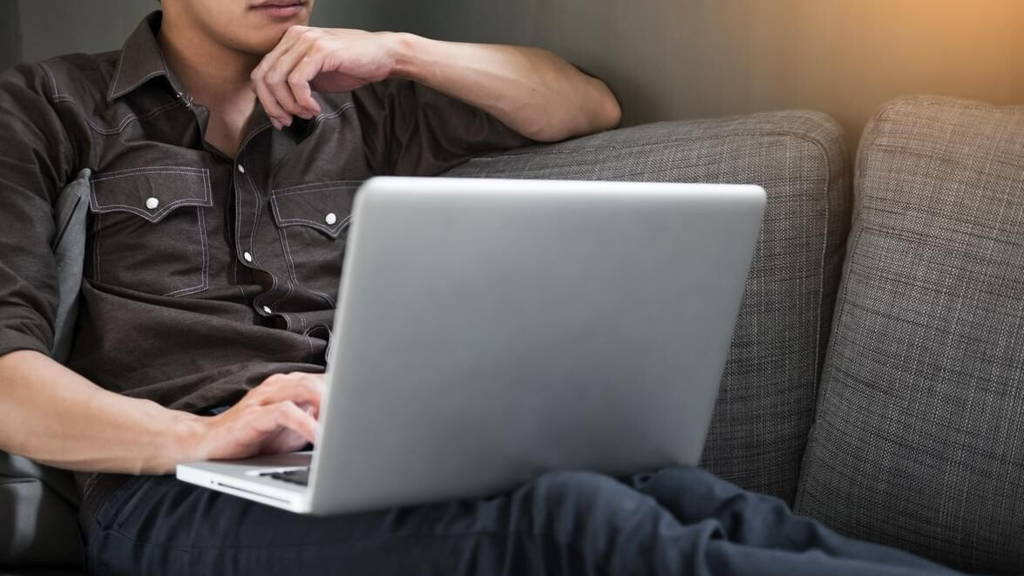 Businessman works on the sofa at home. Work searching for new id