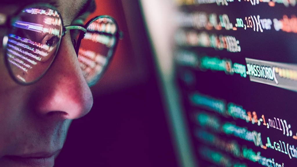 Hacker using computer, smartphone and coding to steal password a