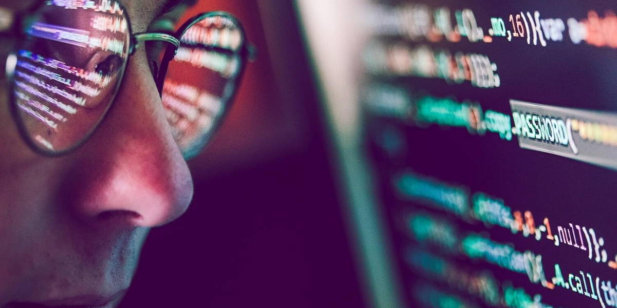 Hacker using computer, smartphone and coding to steal password a