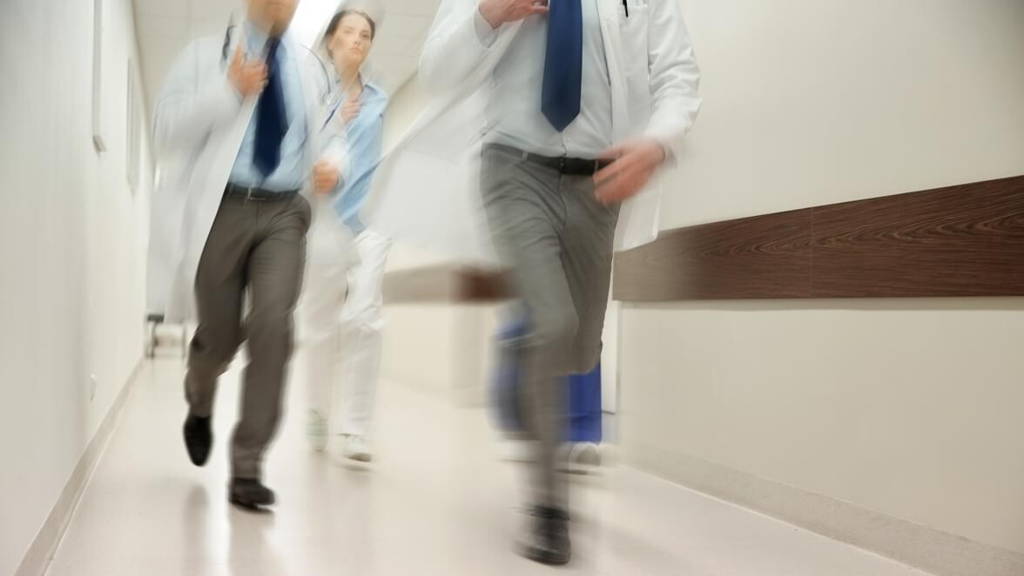 close up of medics or doctors running at hospital