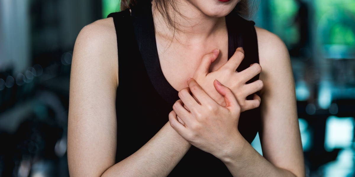 Woman injury pain chest attack heart after workout training exer