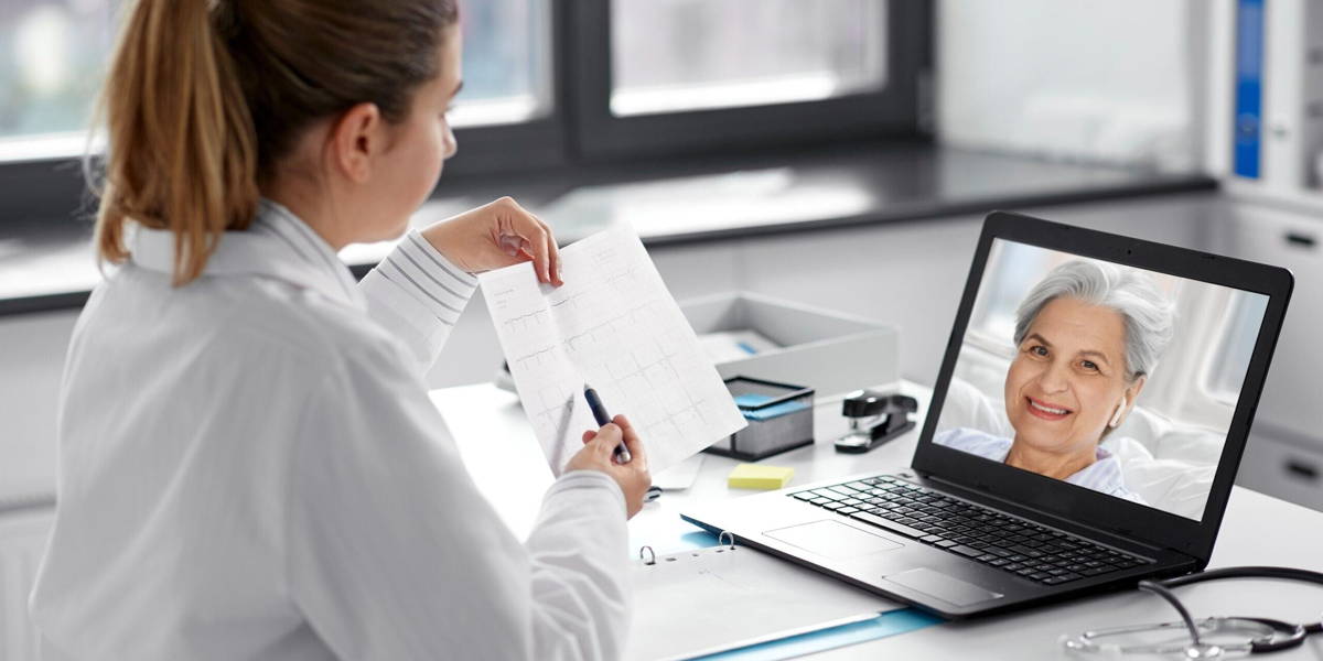 doctor with laptop having video call at hospital