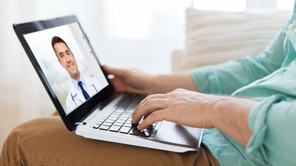 patient having video call with doctor on laptop