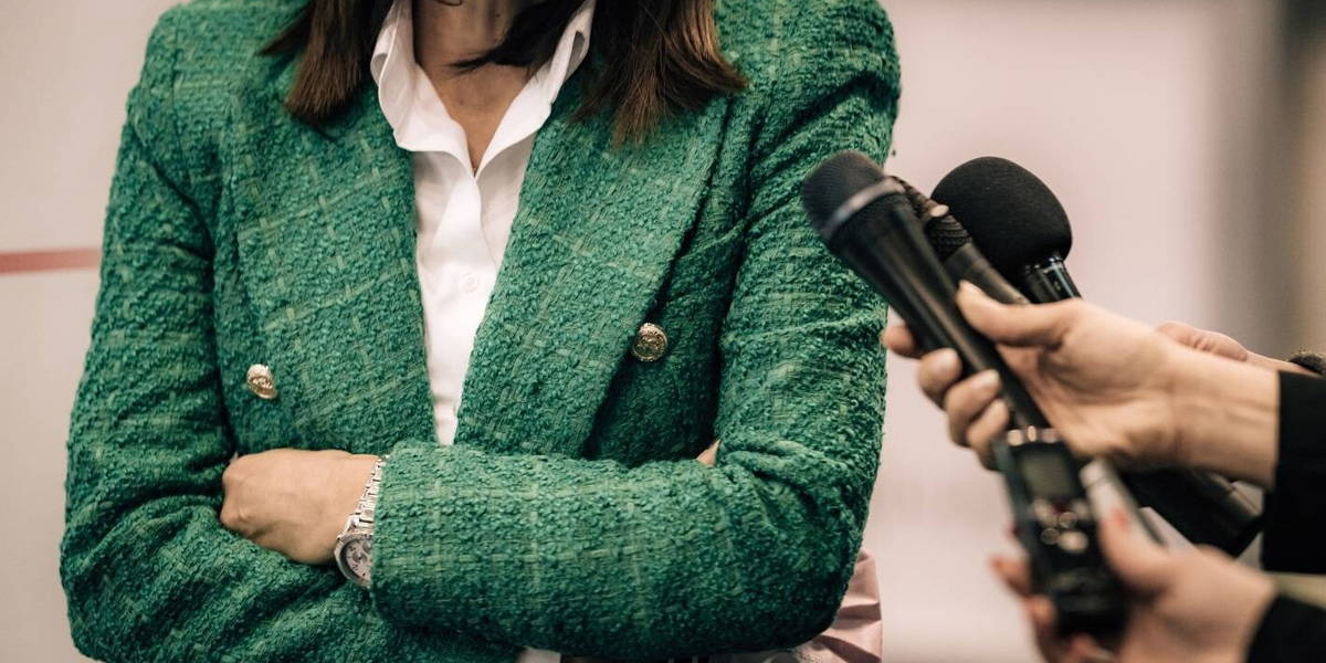 News reporters interviewing a public relations spokesperson