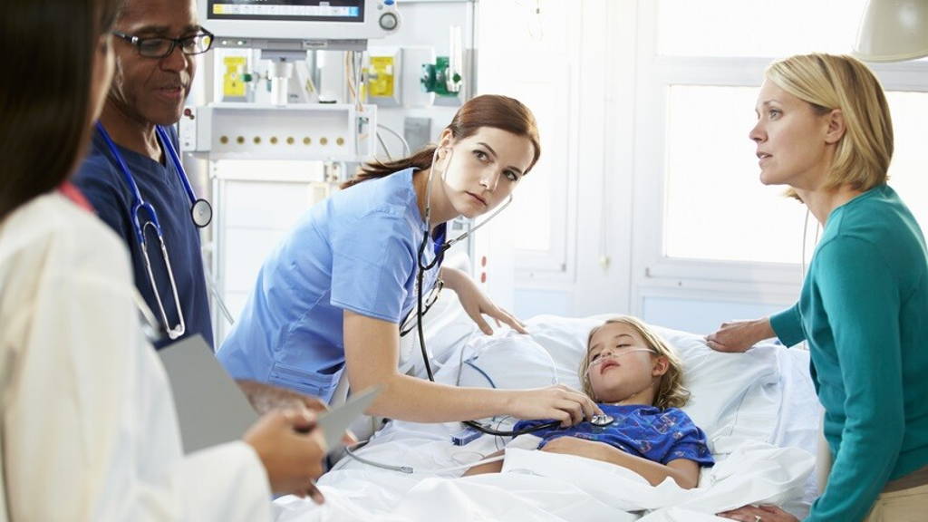 Mother And Daughter With Staff In Intensive Care Unit