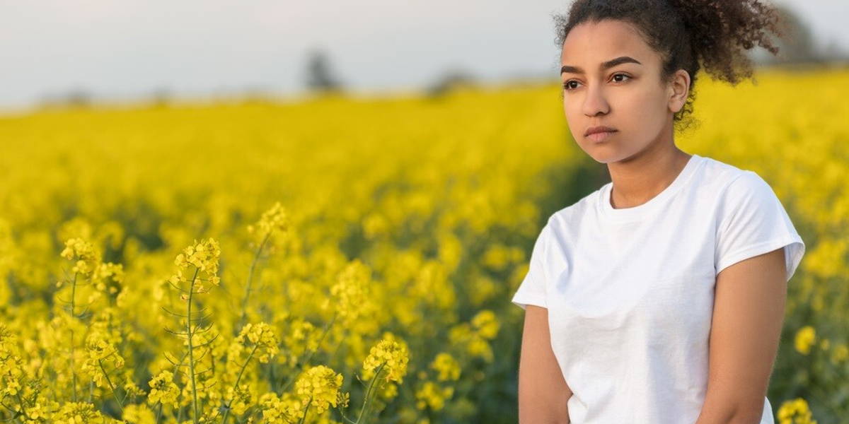 Sad Mixed Race African American Teenager Woman in Yellow Flowers