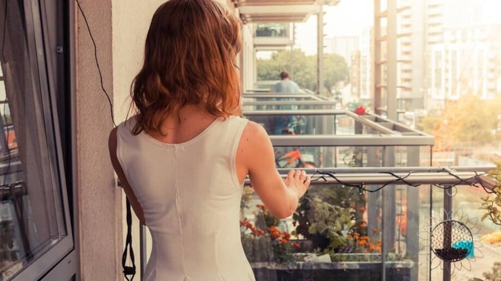 Young woman relaxing on her balcony